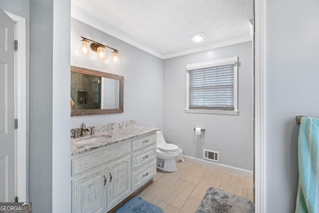 bathroom with crown molding, vanity, a textured ceiling, and toilet