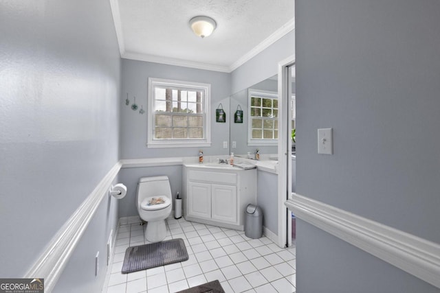 bathroom with tile patterned flooring, vanity, toilet, and crown molding