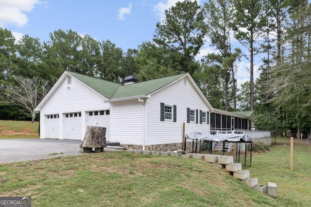 1011 Sugar Hill Way, Buckhead, GA 30625 - view of home's exterior featuring a chimney, a lawn, a sunroom, a garage, and fence