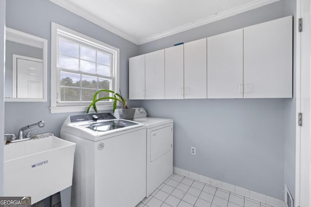 laundry room with cabinets, ornamental molding, washer and clothes dryer, sink, and light tile patterned flooring