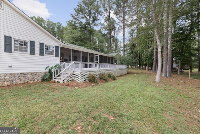 exterior space featuring a sunroom and a yard