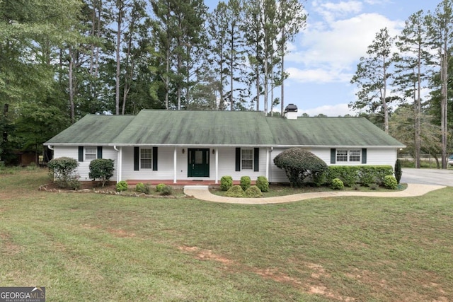 view of front of home with a sunroom, a garage, and a front lawn