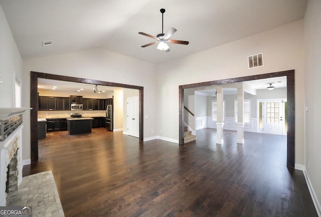 living room with ceiling fan, dark hardwood / wood-style flooring, and high vaulted ceiling