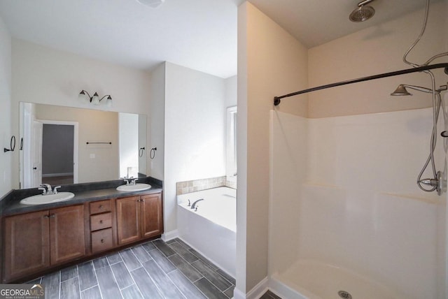 bathroom featuring vanity and shower with separate bathtub