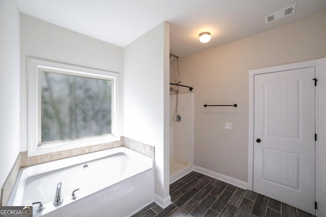 bathroom featuring separate shower and tub