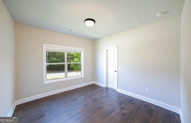 spare room with dark wood-type flooring