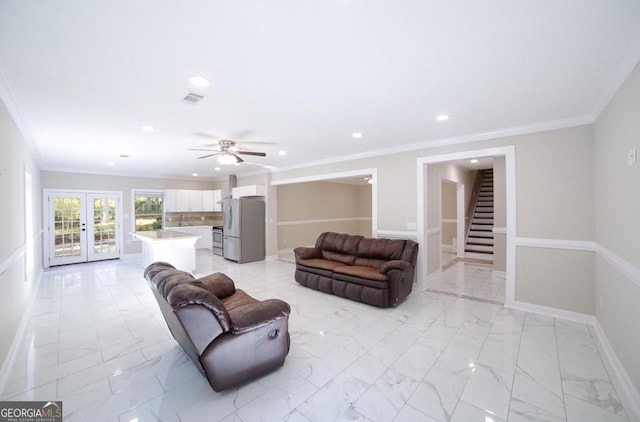 living room with french doors, ornamental molding, and ceiling fan