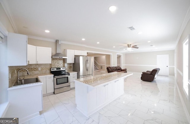 kitchen with white cabinets, sink, wall chimney range hood, stainless steel appliances, and a breakfast bar area