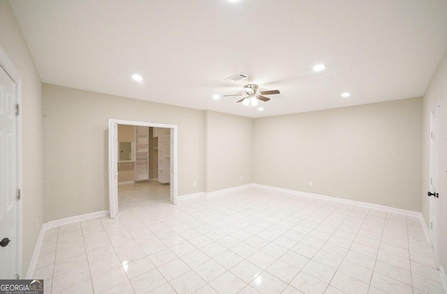 spare room with light tile patterned floors and ceiling fan