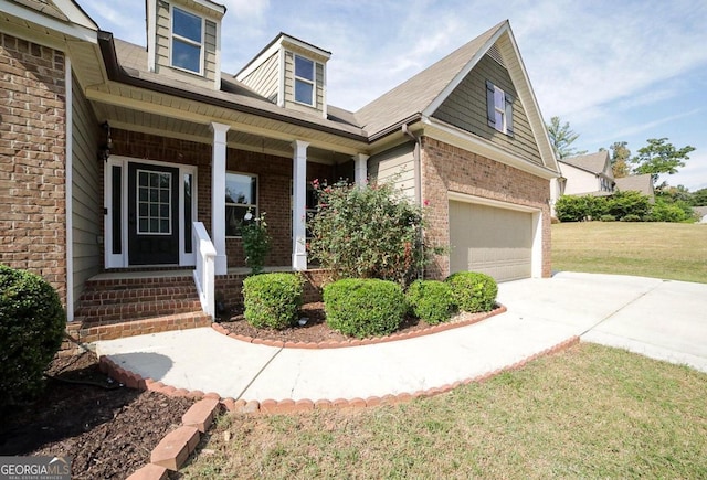 view of front of home with a garage, a porch, and a front lawn