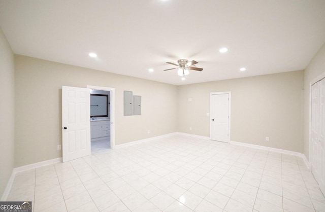 unfurnished room with ceiling fan and electric panel