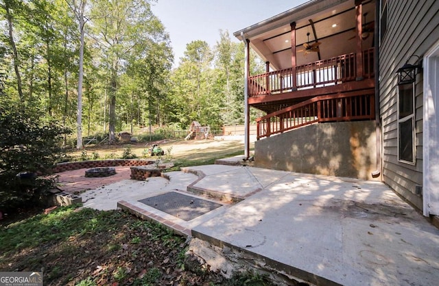 view of patio / terrace featuring a deck and a fire pit