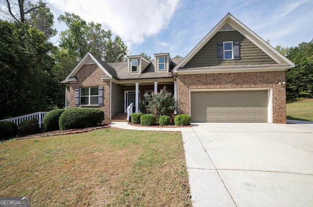 craftsman-style home featuring a garage, a front lawn, and covered porch