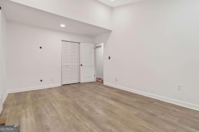 empty room with light hardwood / wood-style flooring