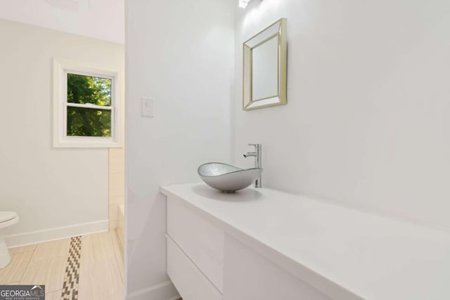 bathroom featuring vanity and toilet