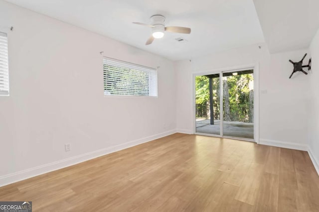 empty room featuring ceiling fan and light hardwood / wood-style flooring