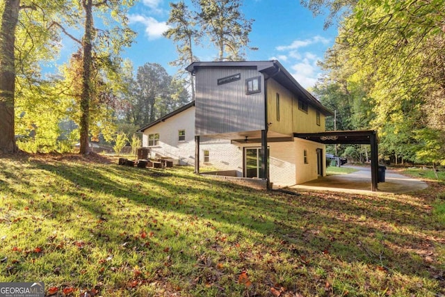 rear view of house featuring a yard and a patio area