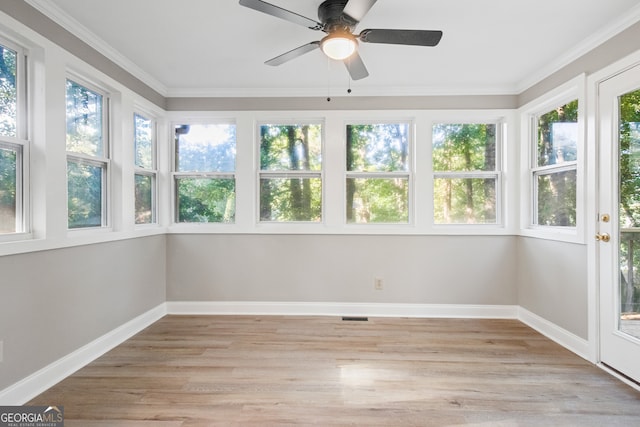 unfurnished sunroom with ceiling fan