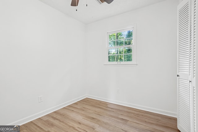 unfurnished bedroom featuring ceiling fan, a closet, and light hardwood / wood-style flooring