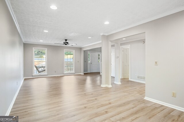 unfurnished living room with ornamental molding, light hardwood / wood-style flooring, a textured ceiling, and ceiling fan