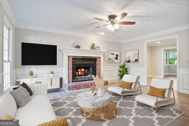 living room featuring crown molding, ceiling fan, and hardwood / wood-style floors