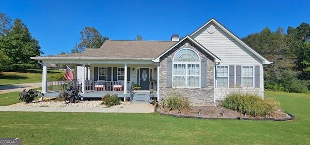 view of front facade with covered porch and a front yard