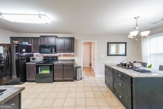 kitchen featuring pendant lighting, light tile patterned floors, tasteful backsplash, black appliances, and an inviting chandelier