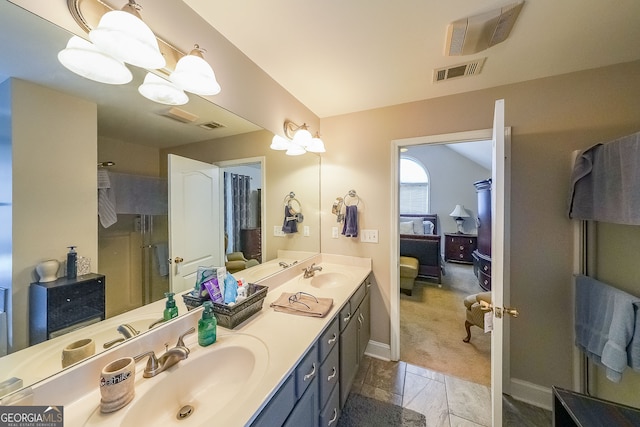 bathroom featuring a shower with door and vanity