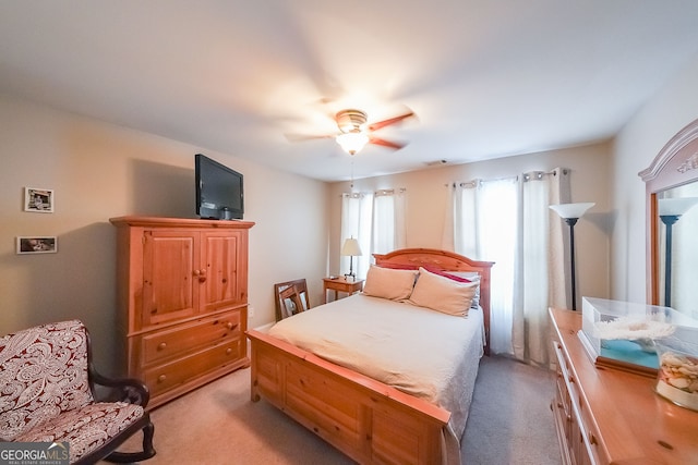 bedroom with ceiling fan and light colored carpet