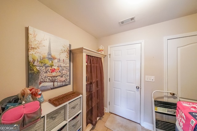 doorway to outside featuring light tile patterned flooring and heating unit