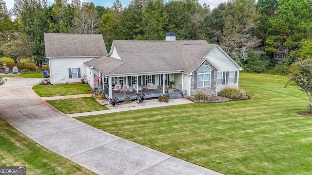 view of front of home with a porch and a front yard