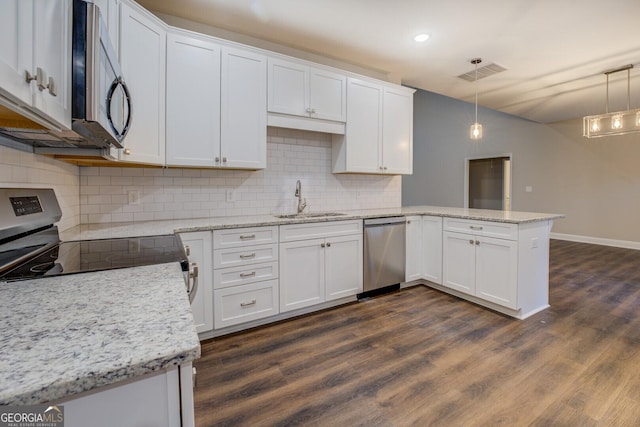 kitchen with white cabinets and hanging light fixtures