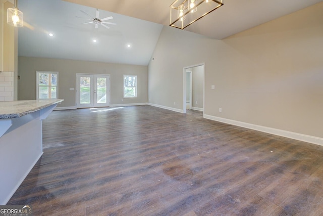 unfurnished living room featuring ceiling fan, french doors, high vaulted ceiling, and dark wood-type flooring