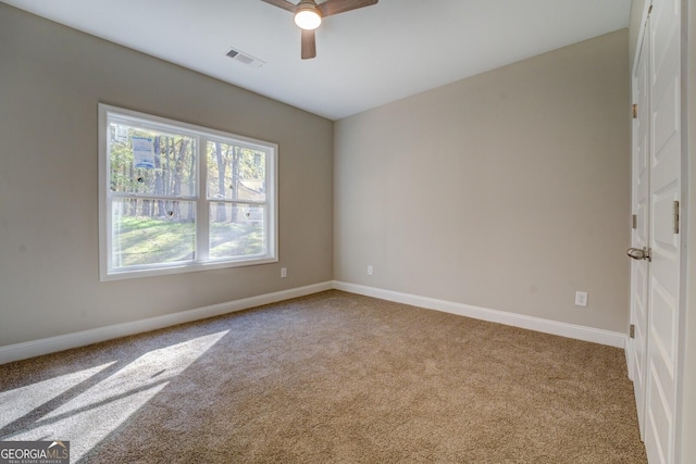 unfurnished room with ceiling fan and light carpet