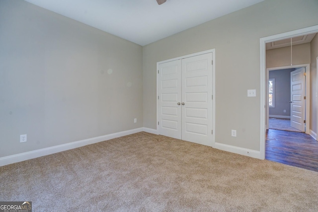 unfurnished bedroom featuring carpet and a closet