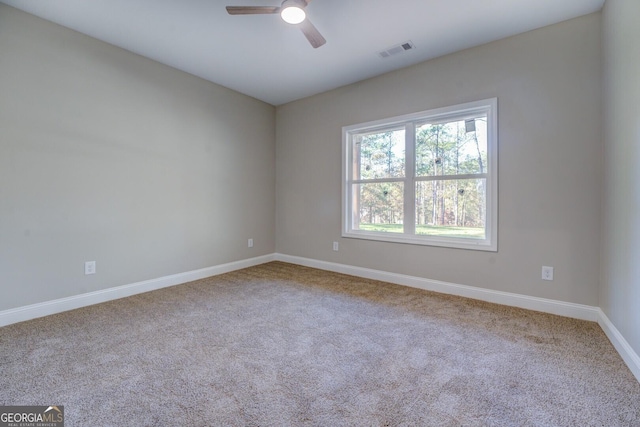 empty room featuring carpet flooring and ceiling fan