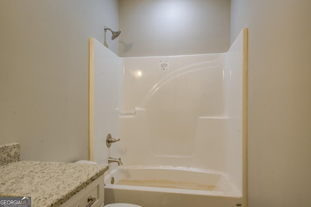 full bathroom featuring bathing tub / shower combination, vanity, and toilet