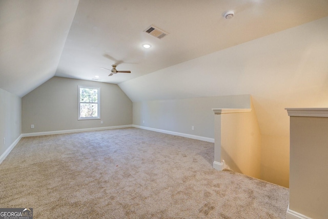 additional living space with ceiling fan, light colored carpet, and lofted ceiling