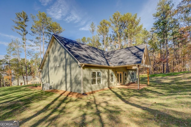 view of home's exterior featuring cooling unit, a yard, and a patio