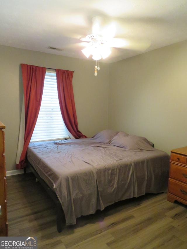 bedroom with hardwood / wood-style floors and ceiling fan