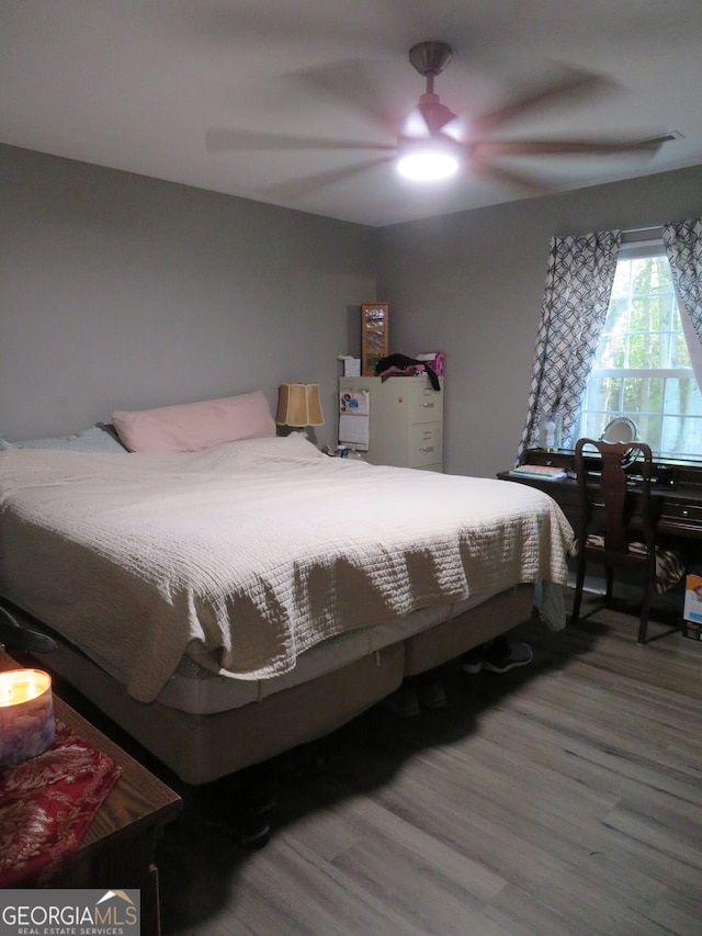 bedroom with wood-type flooring and ceiling fan