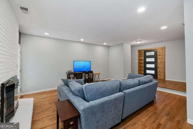 living room featuring hardwood / wood-style flooring and a fireplace