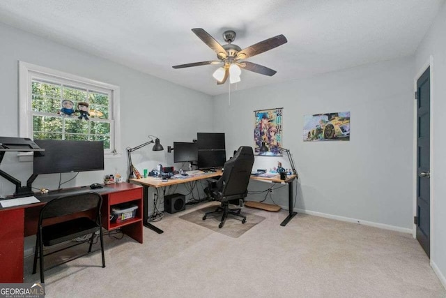 carpeted office featuring ceiling fan