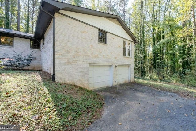 view of side of home featuring a garage