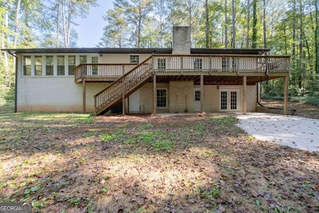 rear view of property with french doors, a patio, and a deck