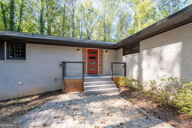 property entrance featuring a patio area