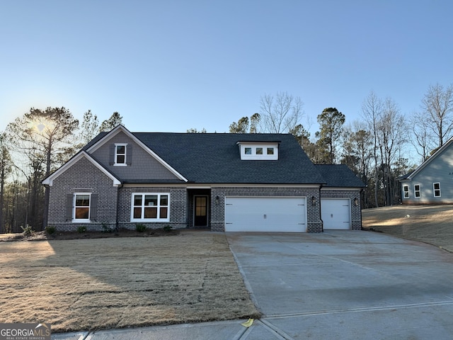 front of property with a front yard and a garage