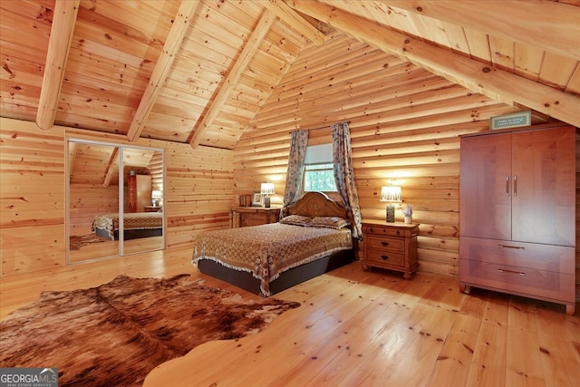 bedroom with light hardwood / wood-style floors, lofted ceiling with beams, log walls, wood ceiling, and wooden walls