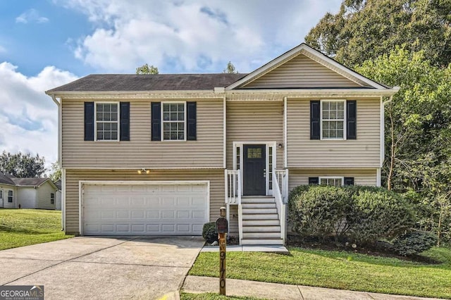 split foyer home featuring a front lawn and a garage