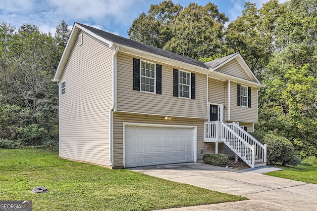 raised ranch featuring a garage and a front lawn